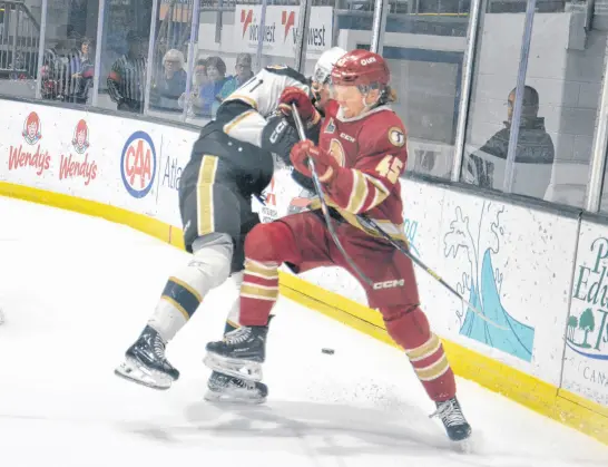  ?? JASON SIMMONDS • THE GUARDIAN ?? Acadie-bathurst Titan defenceman Harry Clements of High Bank, P.E.I., battles with the Charlottet­own Islanders’ Ondrej Maruna, 71, during a recent Quebec Maritimes Junior Hockey League game at Eastlink Centre. Clements is in his second season with the Titan.