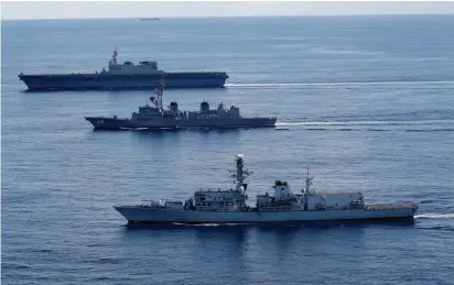  ?? (Kim Kyung-Hoon/Reuters) ?? BRITISH FRIGATE ‘HMS Argyll’ (front), Japanese destroyer ‘Inazuma’ (center) and Japanese helicopter carrier ‘Kaga’ take part in a joint naval drill in the Indian Ocean on Wednesday, before heading to the South China Sea.