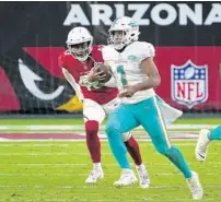  ?? RICK SCUTERI/AP ?? Tua Tagovailoa runs for some of his 35 rushing yards on Sunday in the Dolphins’ win against the Cardinals.