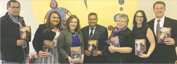  ??  ?? Elder Travis Plaited Hair, from left, Jennifer Houle-famakine, Children’s Services Minister Rebecca Schulz, MLA Peter Singh, elder Gloria Laird, executive director of the Centre for Suicide Prevention Mara Grunau and MLA Jeremy Nixon unveil new suicide prevention graphic novels for First Nations and Metis youth.