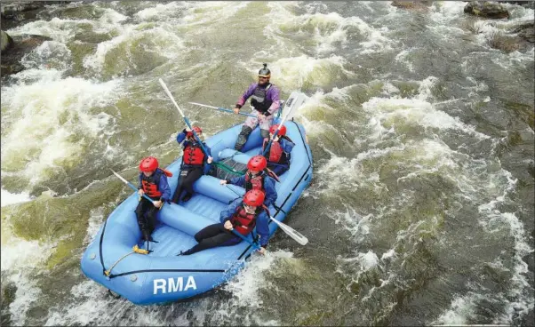  ??  ?? Dylan Dems, a rafting guide for Rocky Mountain Adventures, takes a group down a whitewater section of the Cache la Poudre River on June 23 near Fort Collins, Colo. (AP/Thomas Peipert)