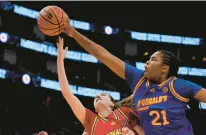  ?? KEVIN M. COX/AP ?? West guard Morgan Cheli, left, is blocked by East forward Sarah Strong during the first quarter of the McDonald’s All American girls basketball game on April 2 in Houston.