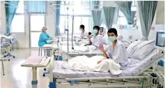  ?? ?? A screen grab shows boys rescued from the Thai cave wearing mask and resting in a hospital in Chiang Rai, Thailand from a July 11, 2018 handout video. (Government Public Relations Department and Government Spokesman Bureau/Handout via Reuters TV)