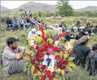  ?? AP PHOTO ?? Relatives, colleagues and friends attend the funeral of AFP chief photograph­er, Shah Marai, who was killed in Monday’s second suicide attack, in Guldara, a district of Kabul province, Afghanista­n, Monday.