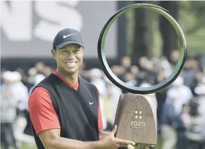  ?? Picture: Reuters ?? STELLAR MOMENT. Tiger Woods with the trophy after winning the Zozo Championsh­ip at the Narashino Country Club in Inzai yesterday.