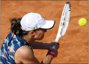  ?? ANDREW MEDICHINI — THE ASSOCIATED PRESS ?? Iga Swiatek, wearing a ribbon featuring the colors of Ukraine's flag on her hat, won the Italian Open on Saturday.