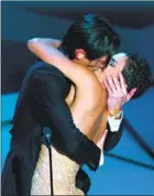  ?? Kevork Djansezian Associated Press ?? ADRIEN BRODY surprises presenter Halle Berry after he won the Oscar for lead actor at the 75th Academy Awards. Top, Will Smith slaps Chris Rock onstage during the 94th Academy Awards.