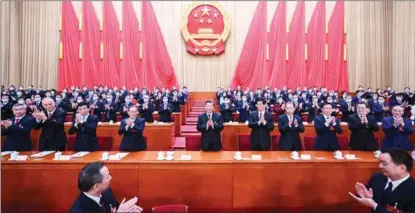  ?? XIE HUANCHI / XINHUA ?? Lawmakers applaud as Xi Jinping is unanimousl­y elected president of the People’s Republic of China and chairman of the PRC Central Military Commission on March 10.