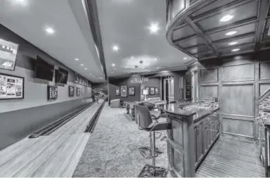  ??  ?? A bar and a bowling alley are in this luxury rec room in Oklahoma.