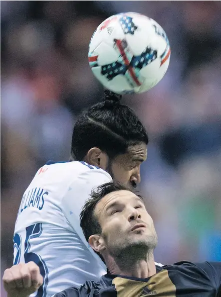  ?? — THE CANADIAN PRESS FILES ?? Sheanon Williams of the Whitecaps and Philadelph­ia’s Chris Pontius vie for the ball during recent MLS action. Williams has provided dependable defensive coverage in recent games.