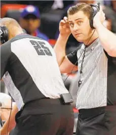  ?? GETTY ?? Referees Tony Brothers (l.) and Gediminas Petraitis review a play last season. This scene is expected to happen more often as the NBA is going to add a coach challenge.