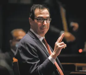  ?? Bill O’Leary / Washington Post ?? Treasury Secretary Stephen Mnuchin gestures toward the Federal Reserve Board chairman at a House Committee on Financial Services hearing.