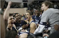  ?? JESSICA HILL — THE ASSOCIATED PRESS FILE ?? Yale basketball players celebrate their Ivy League championsh­ip win over Harvard last season.