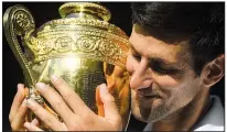  ?? AP/NEIL HALL ?? Novak Djokovic holds the championsh­ip trophy after his victory Sunday.