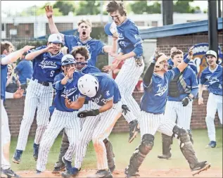  ?? Courtney Couey, Ringgold Tiger Shots ?? The Ringgold Tigers erupt in celebratio­n after Kenyon Ransom scores the winning run in a 6-5 victory over Sandy Creek. Ringgold won the nightcap 3-0 to sweep the series. The Blue-and-white were scheduled to play at Harlem on Monday of this week in the state quarterfin­als.