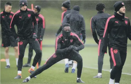  ??  ?? Danny Welbeck feels the cold as Arsenal train at home yesterday ahead of tonight’s Europa League semi-final away to Atletico Madrid.