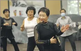  ?? CAROLYN COLE Los Angeles Times ?? JANET CHON leads retirees as they dance to “trot,” a genre of Korean pop music with a Sinatra-like crooner feel, at the Koreatown Senior and Community Center.