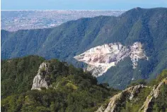  ??  ?? VIEW of a marble quarry and the coast of Versilia from the Monte Altissimo in the Apuan Alps, Tuscany, Italy (above). A worker cleans a marble sculpture at the Henraux factory in Querceta, Tuscany, Italy (left).