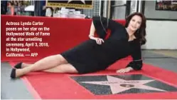  ??  ?? Actress Lynda Carter poses on her star on the Hollywood Walk of Fame at the star unveiling ceremony, April 3, 2018, in Hollywood, California. — AFP