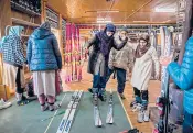  ??  ?? People try on rental ski equipment in February at Gulmarg.