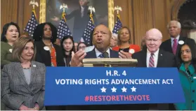  ?? J. Scott Applewhite / Associated Press ?? Rep. John Lewis, DGa. (center), joins Speaker Nancy Pelosi, DSan Francisco, and Sen. Patrick Leahy, DVt., at a voting rights event in Washington on Dec. 6.