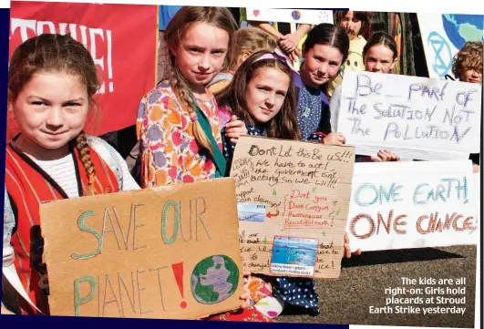  ??  ?? The kids are all right-on: Girls hold placards at Stroud Earth Strike yesterday