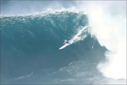  ?? PICTURE: WSL/HEFF ?? JUMBO WAVE: Grant ‘Twiggy’ Baker is dwarfed by this huge wall of water on his way to third place in the Pe’ahi Challenge in Hawaii.