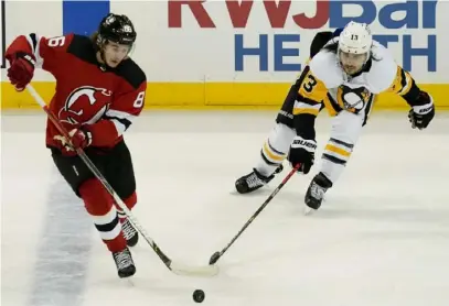  ?? Associated Press ?? Brandon Tanev defends against Devils center Jack Hughes in a 3-2 loss March 18 in Newark, N.J.