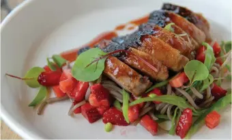  ??  ?? SPICY barbecue duck legs with strawberri­es and soba noodles at the Three Sisters restaurant at Blackberry Mountain. | The New York Times