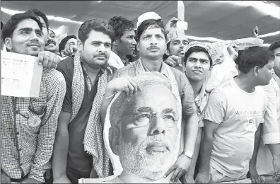  ??  ?? Supporters of India’s main opposition and Hindu nationalis­t Bharatiya Janata Party (BJP) prime ministeria­l candidate Narendra Modi attend a political rally in Robertsgan­j, in the northern Indian state of Uttar Pradesh, May 10. During his campaign, Modi...