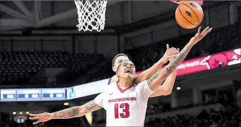  ?? NWA Democrat-Gazette/J.T. WAMPLER ?? Arkansas senior forward Dustin Thomas is fouled by fighting for a rebound with Javan White of Oral Roberts during Tuesday night’s game at Walton Arena in Fayettevil­le. Arkansas won 104-69 to improve to 9-2.