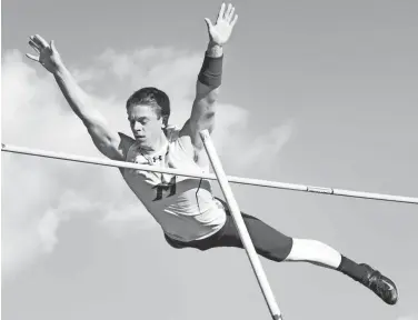  ?? DAVE KALLMANN / MILWAUKEE JOURNAL SENTINEL ?? Mukwonago’s Bailey Kroll clears 14 feet to guarantee at least second place in the boys pole vault at the Myrhum Invitation­al. Check out more photos from the Myrhum Invitation­al at www.jsonline.com/preps.