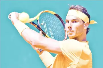  ?? — AFP photo ?? Spain’s Rafael Nadal plays a backhand return to Austria’s Dominic Thiem during their singles tennis match at the Monte-Carlo ATP Masters Series tournament in Monaco on April 20, 2018.