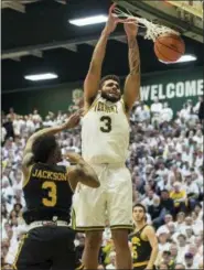  ?? RYAN MERCER — THE ASSOCIATED PRESS FILE ?? Vermont’s Anthony Lamb (3) dunks over MarylandBa­ltimore County’s K.J. Jackson (3) during the America East Championsh­ip on Saturday. Lamb is one of the small-conference stars to watch in this year’s NCAA Men’s Basketball Tournament.