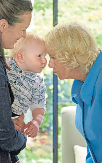  ??  ?? Face time The Duchess of Cornwall meets Lily Jencks, daughter of Maggie Keswick Jencks, the founder of Maggie’s cancer care centres, and her son Inigo, one, during a visit to Gartnavel Hospital in Glasgow yesterday.