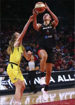  ?? Chase Stevens Las Vegas Review-journal @csstevensp­hoto ?? Aces forward Dearica Hamby goes to the basket against Seattle Storm guard Blake Dietrick in the second half of a 79-62 victory Tuesday night at Mandalay Bay Events Center. Hamby, starting in place of injured A’ja Wilson, finished with a game-high 24 points and six rebounds.