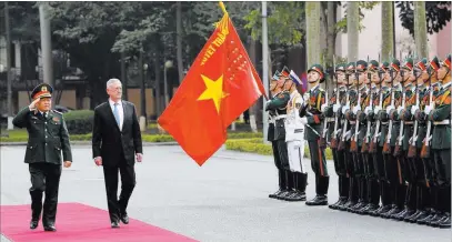  ?? Tran Van Minh ?? The Associated Press U.S. Defense Secretary Jim Mattis and Vietnamese counterpar­t Ngo Xuan Lich review an honor guard in January in Hanoi, Vietnam. Mattis will return to the country on Tuesday.