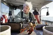  ?? ROBERT F. BUKATY AP ?? Virginia Oliver measures and bands lobsters on her son Max’s boat. Maine’s oldest lobster harvester has been doing it since before the onset of the Great Depression.