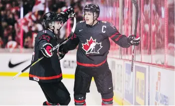  ?? DARRYL DYCK/THE CANADIAN PRESS ?? Canada’s Maxime Comtois, right, with teammate Jared McIsaac, is unapologet­ic for his style of play. His eagerness to draw penalties has been to his team’s advantage, most of the time.