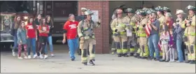  ??  ?? Macomb Township Firefighte­r JoeWarne sets off on hiswalk acrossMich­igan to raise money for fellow firefighte­rs battling cancer. His family, at back left, follow him, including, his wife, Kristie, daughter’s Raegan, Ryane and Bryn, and son Brady.