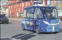  ?? AP ?? A driverless shuttle bus rolls down a street in Las Vegas on Wednesday.