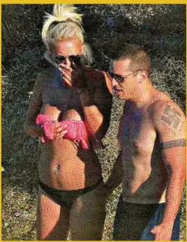  ??  ?? Elias Kasidiàris, an MP for Greek neo-Nazi party Golden Dawn, sporting a swastika tattoo during his beach holiday last week. This picture appeared on the front page of national newspaper Poto Thema last weekend