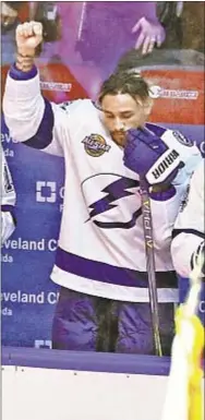  ?? AP ?? Lightning’s J.T. Brown causes stir around NHL when he raises fist during national anthem before game.