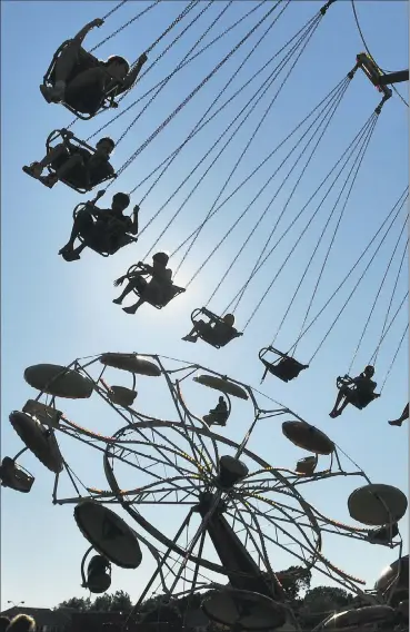  ?? Hearst Connecticu­t Media file photo ?? Fairgoers ride on a Ferris wheel during a previous Savin Rock Festival in West Haven.