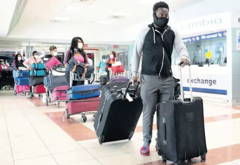  ?? FILE ?? Persons returning to Jamaica after resumption of air travel. Tourism, airlines, and travel companies have been among the worst hit from the pandemic. With no real business-continuity insurance in Jamaica, they and other businesses are unlikely to recover foregone income.