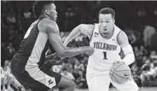  ?? THE ASSOCIATED PRESS ?? Villanova’s Jalen Brunson, right, drives past Providence’s Rodney Bullock during the first half of Saturday’s Big East tournament championsh­ip game in New York.