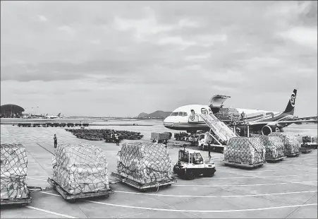  ?? PROVIDED TO CHINA DAILY ?? Cargoes are loaded onto an aircraft of SF Airlines, China’s largest air cargo carrier, at Hangzhou Internatio­nal Airport in Hangzhou, capital of Zhejiang province, on March 25.
