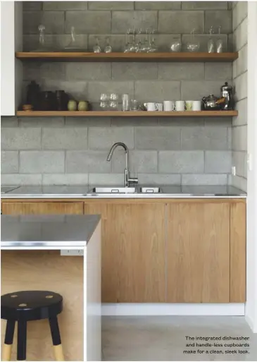  ??  ?? The integrated dishwasher and handle-less cupboards make for a clean, sleek look.