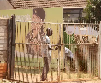  ??  ?? An unidentifi­ed man locks the gate at Jah Prayzah’s offices yesterday as they allowed no one into the premises