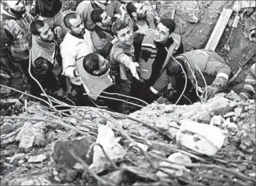  ?? SUHAIB SALEM/REUTERS PHOTO ?? Palestinia­n members of the Civil Defense help a man out of the rubble after an Israeli strike destroyed his home Sunday.